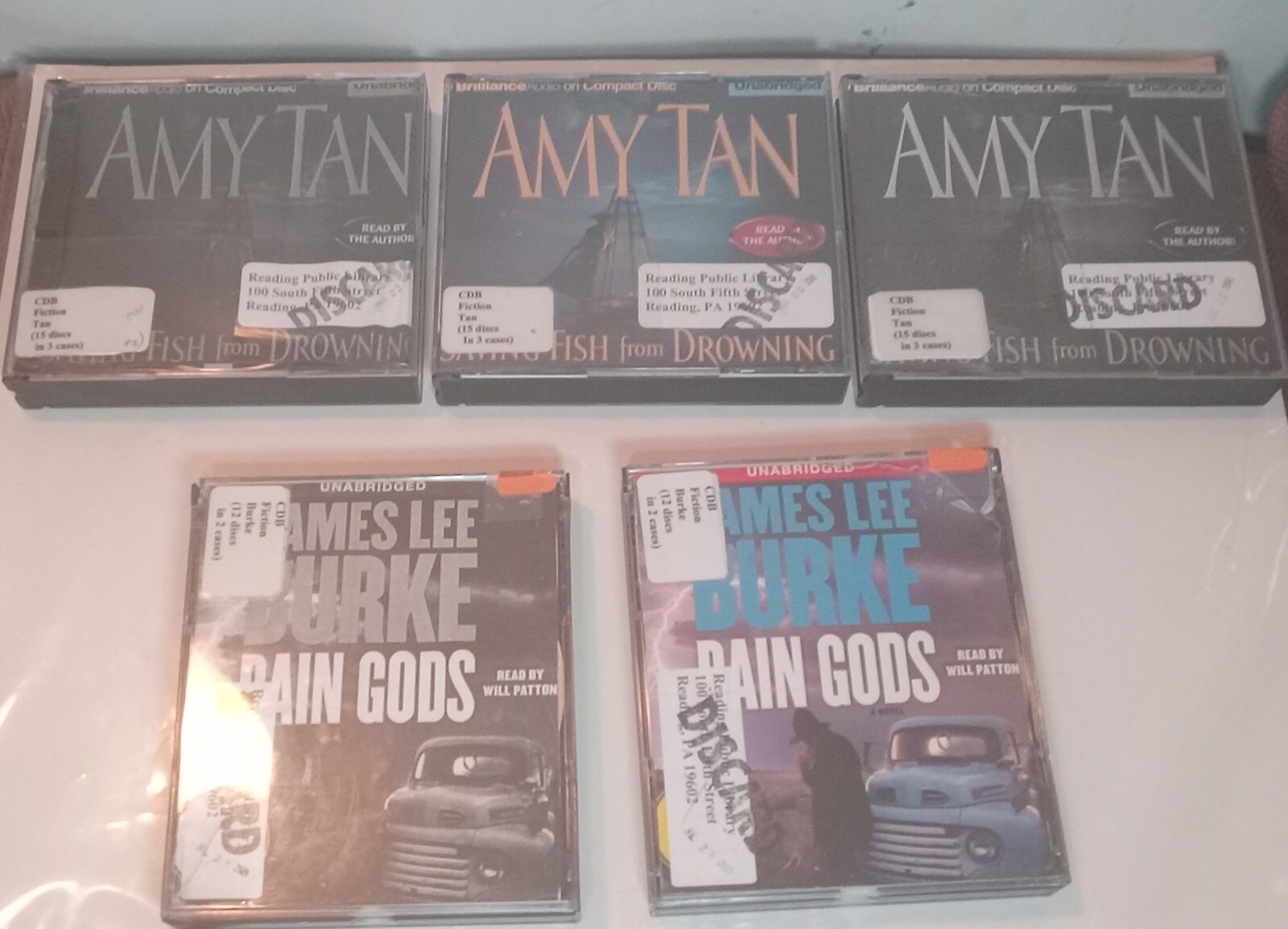2 (Audiobooks Rain Gods & Saving Fish From Drowning) Mystery / Library Discard